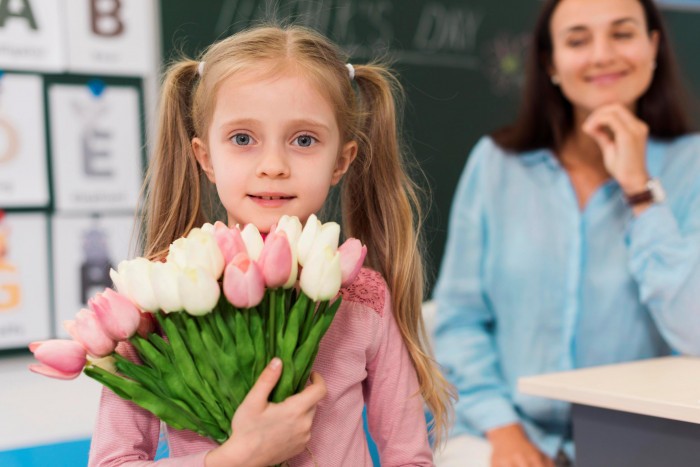 little girl holding bouquet flowers her teacher