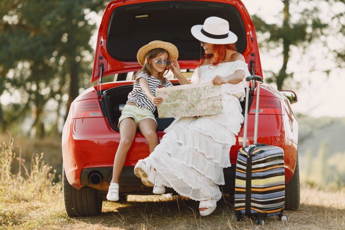little girl ready go vacations mother with daughter examining map traveling by car with kids