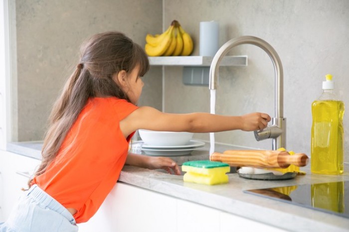 cute little girl washing dish kitchen by herself child reaching kitchen sink faucet tap turning water 74855 8029