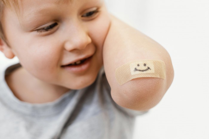 close up kid with smiley patch