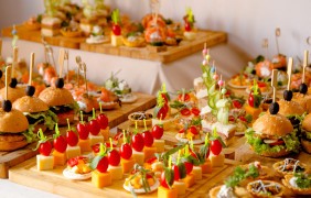 buffet table with snacks from burgers cheeses etc 1