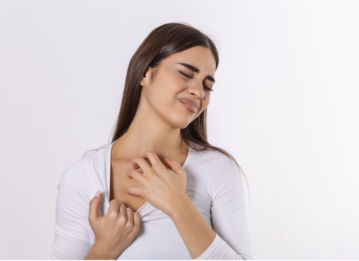 young woman scratching her neck due itching gray background female has itching neck concept allergy symptoms healthcare