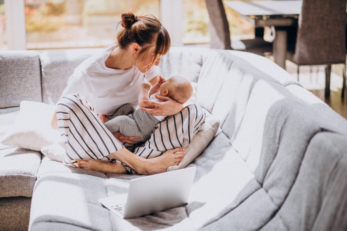 young mother with her kid working home computer